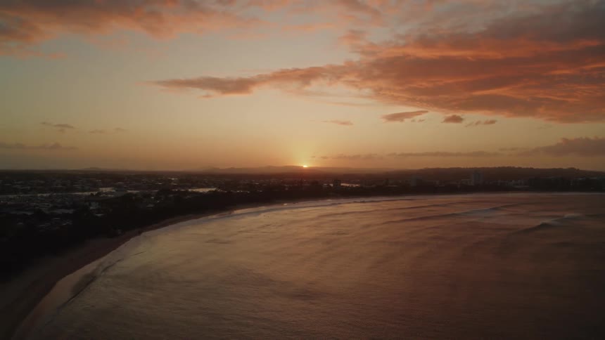 The sun sets over the coast