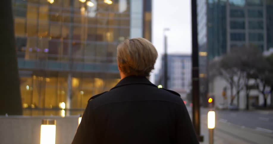 A man walking down a sidewalk in the city