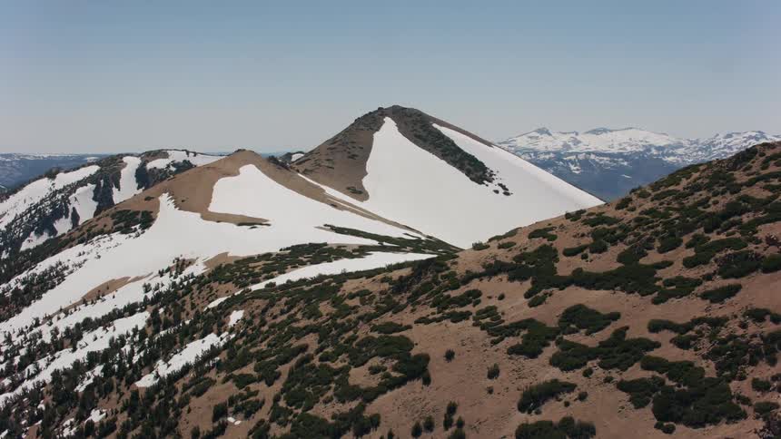Mountain peaks partially covered in snow