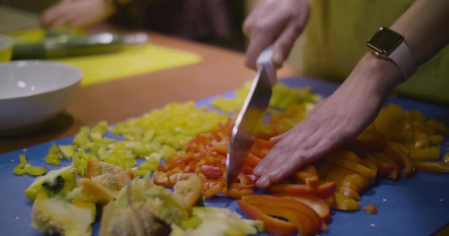 A person chops vegetable