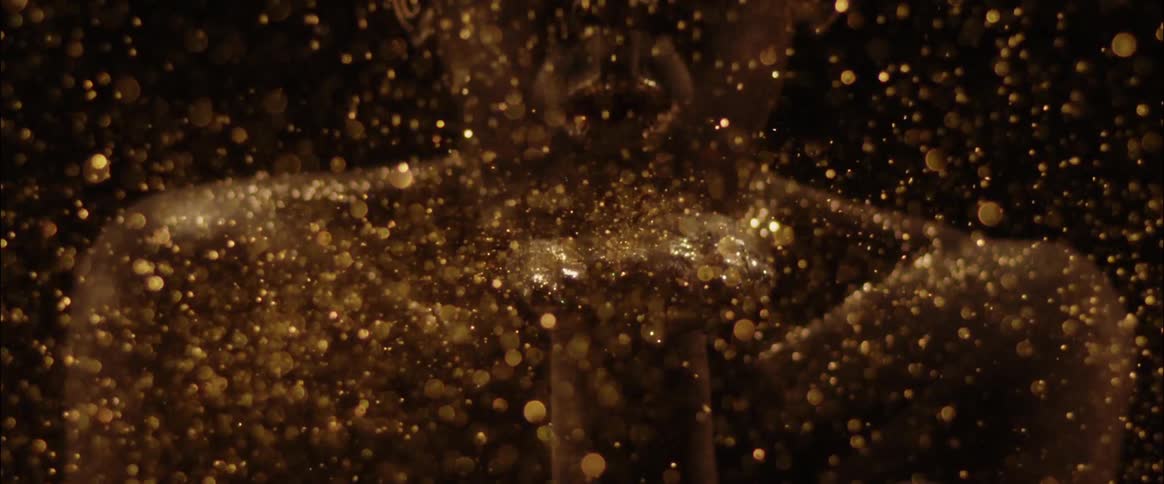 Slow motion of someone blowing and covered in glitter