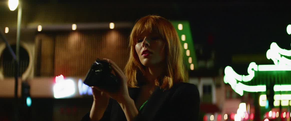 Woman takes a photo of herself with a camera