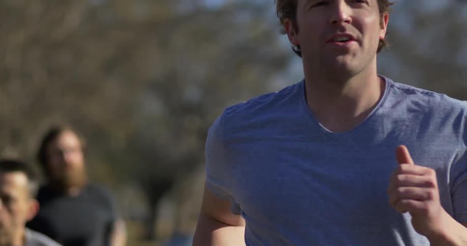 A man leads a group of jogging men