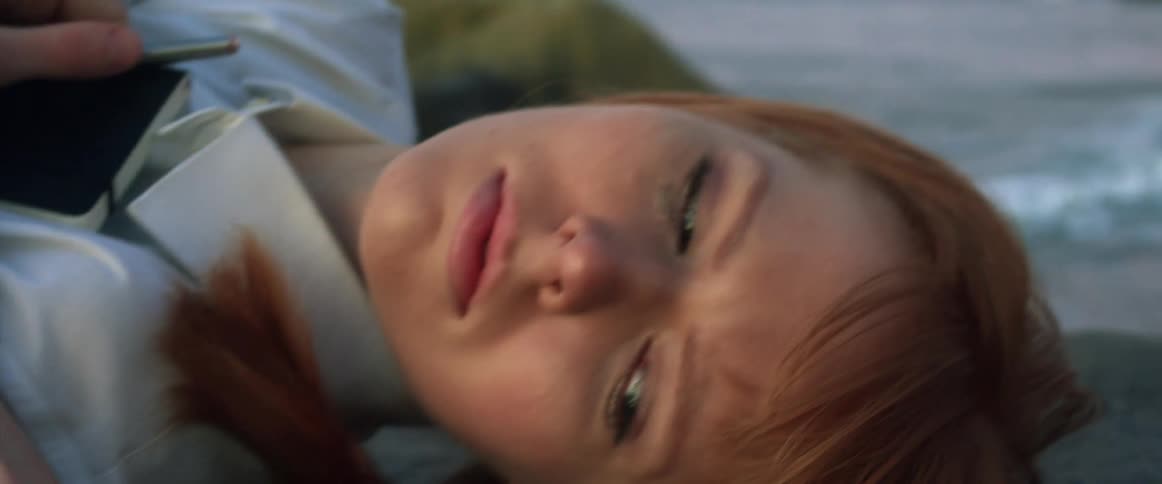 A woman is laying on the beach