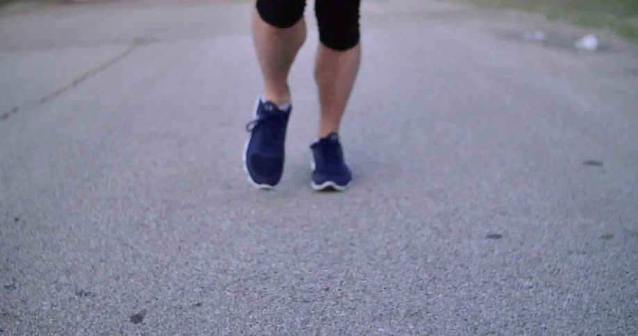 A man jogging along a street