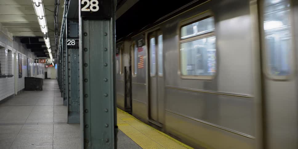 A subway station with a train arriving