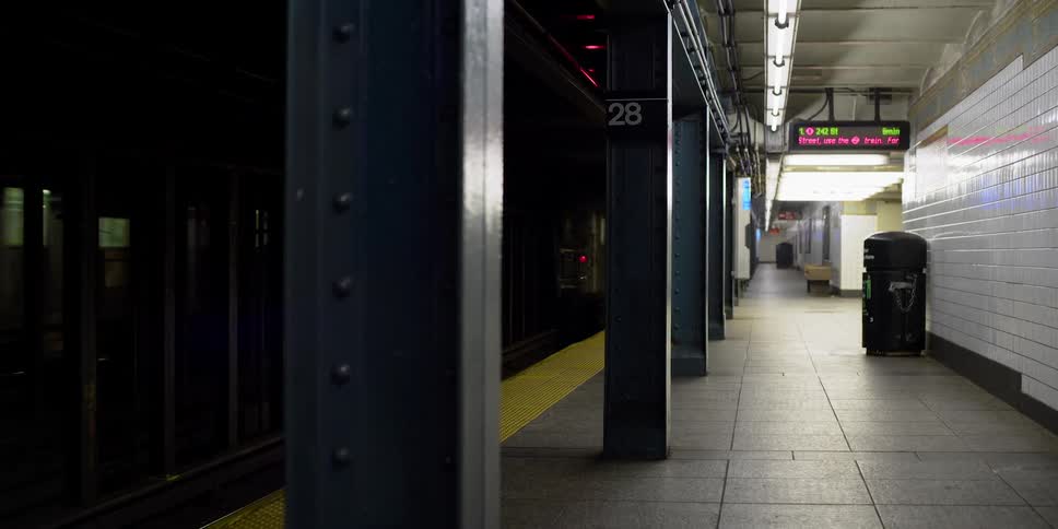 A train drives through an empty station