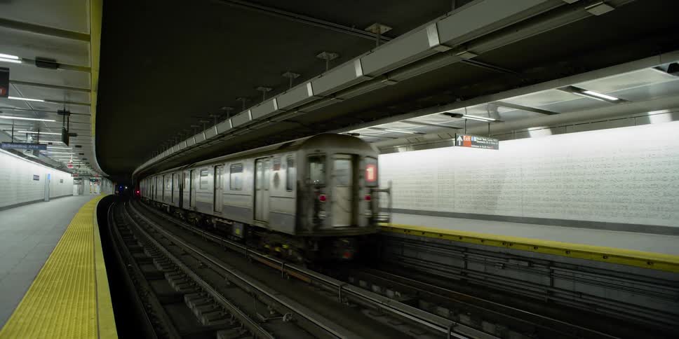 A subway train goes through an empty subway station