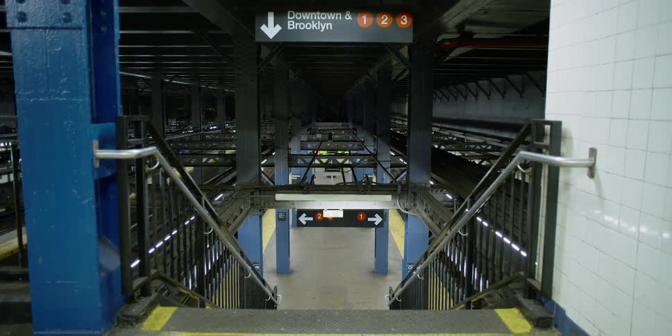 Empty steps lead down to an empty subway platform in new york