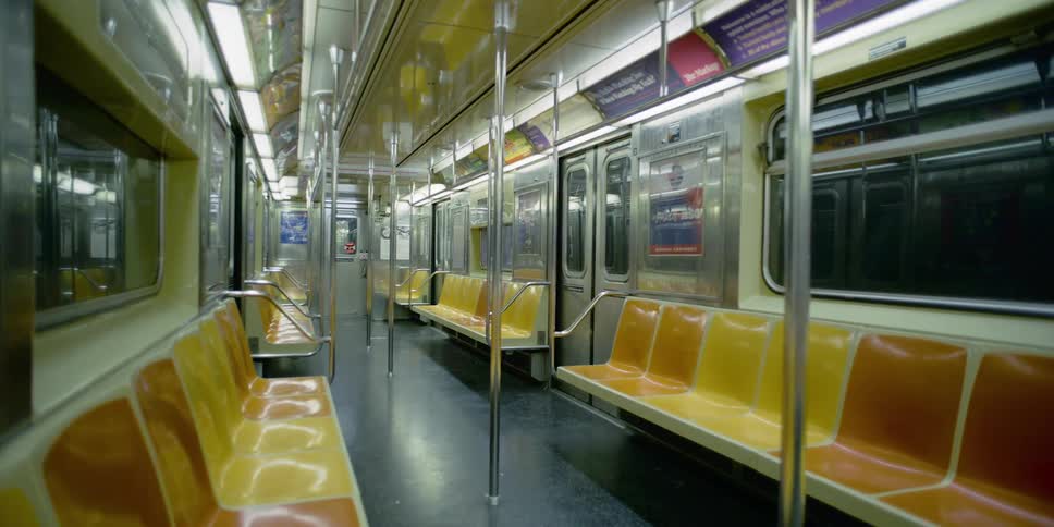 An empty subway cart riding underground