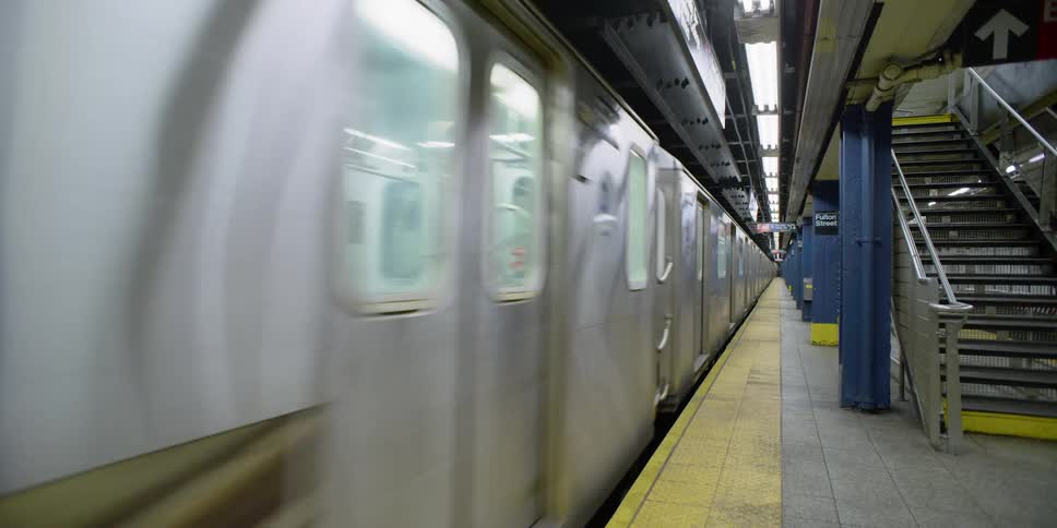 Static shot of a subway moving through a station
