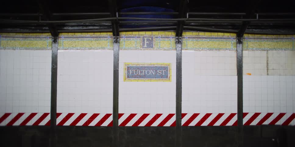 A sign in an empty train station