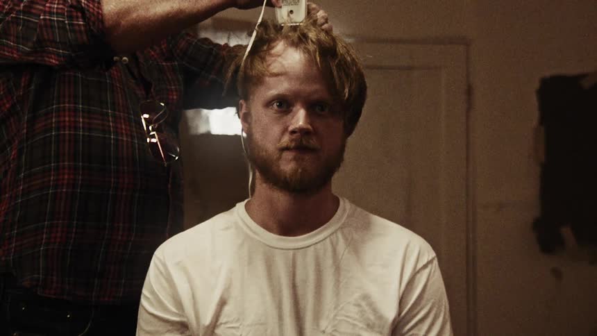 A man getting his head shaved