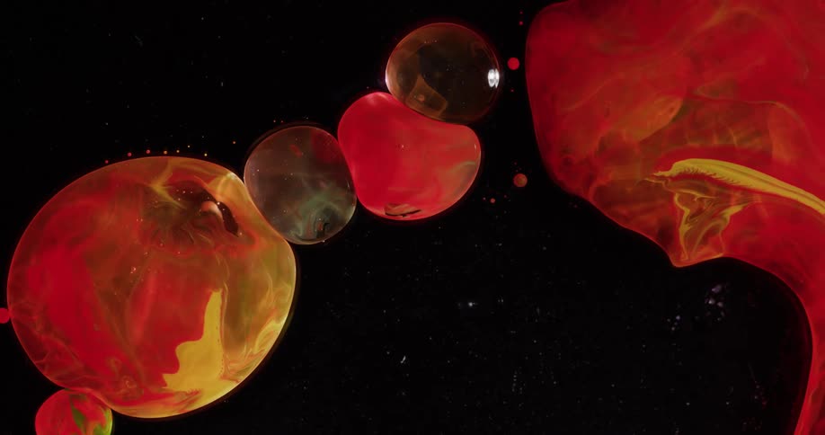 Globules of red and black liquid pressing against each other