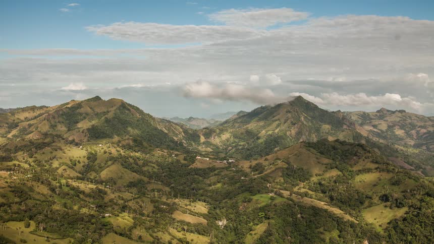 Clouds form and float over mountains