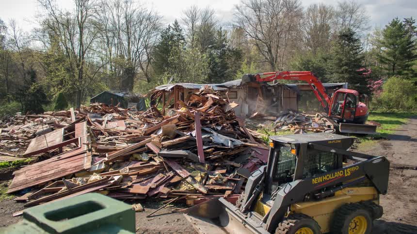 A house is demolished during the day
