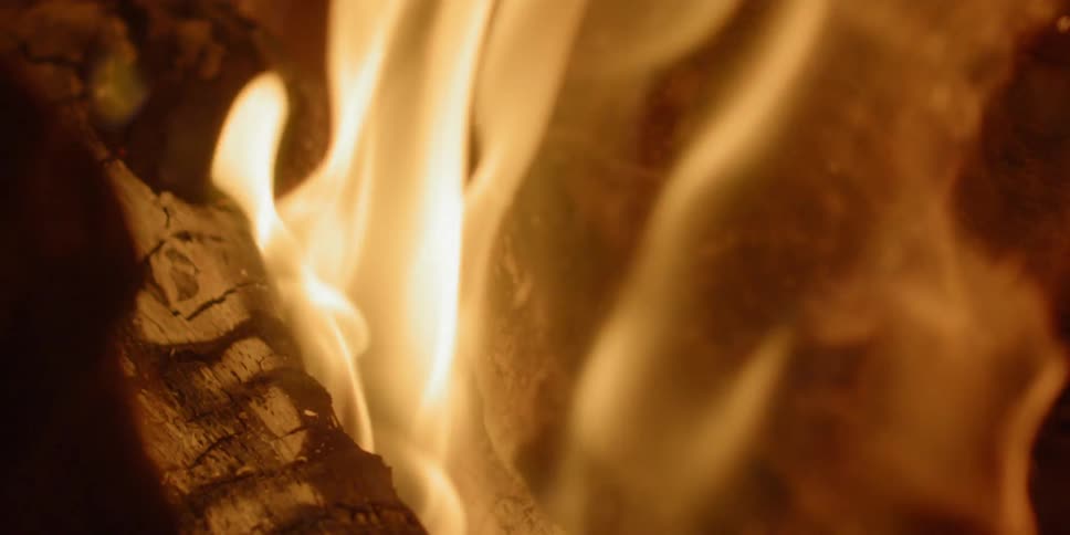 A log burns an orange flame