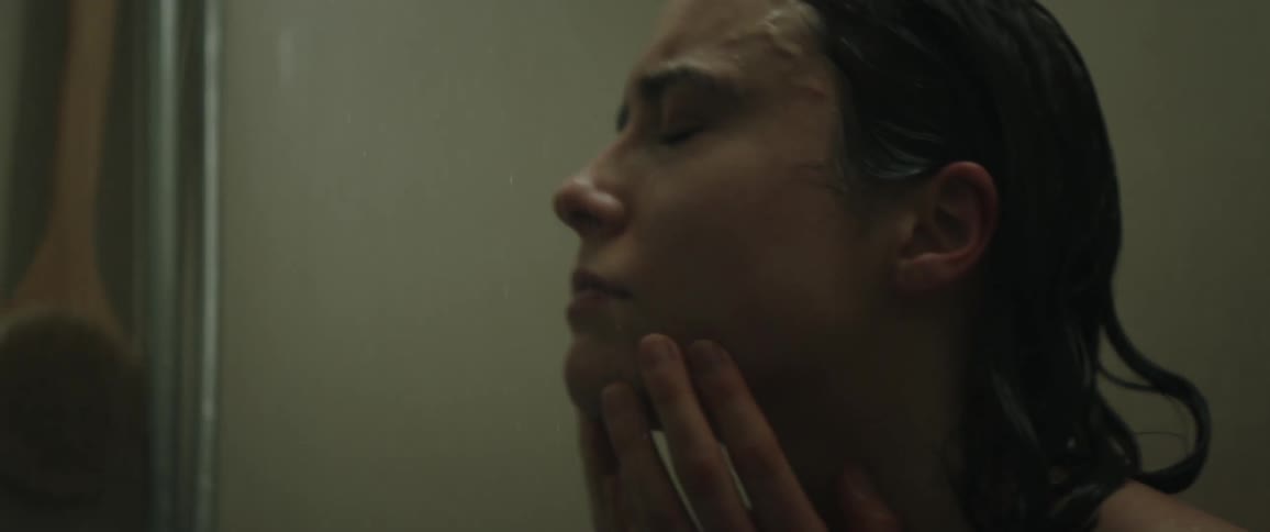 Sad woman taking a shower in the bathroom