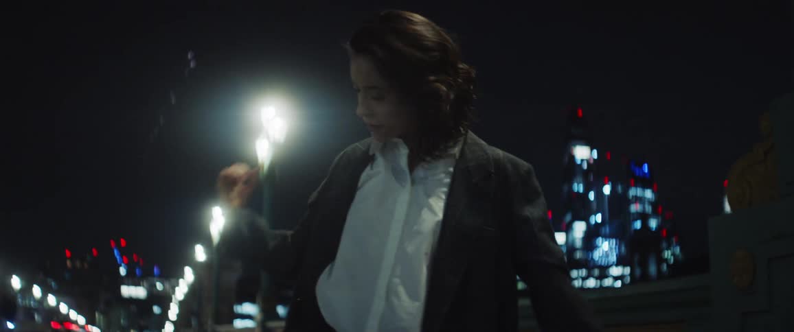 A woman expressing sadness by dancing on a london bridge