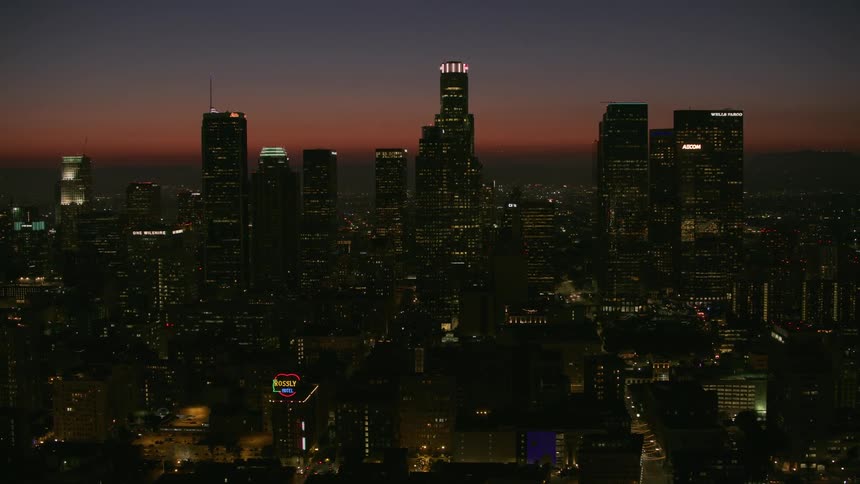 Aerial view of a downtown city during the night time is displayed