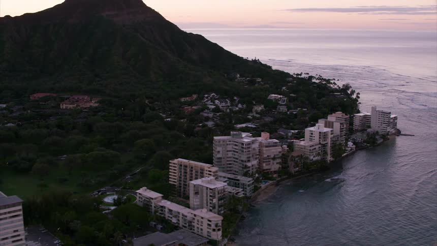 A city beside the sea with a mountain next to both