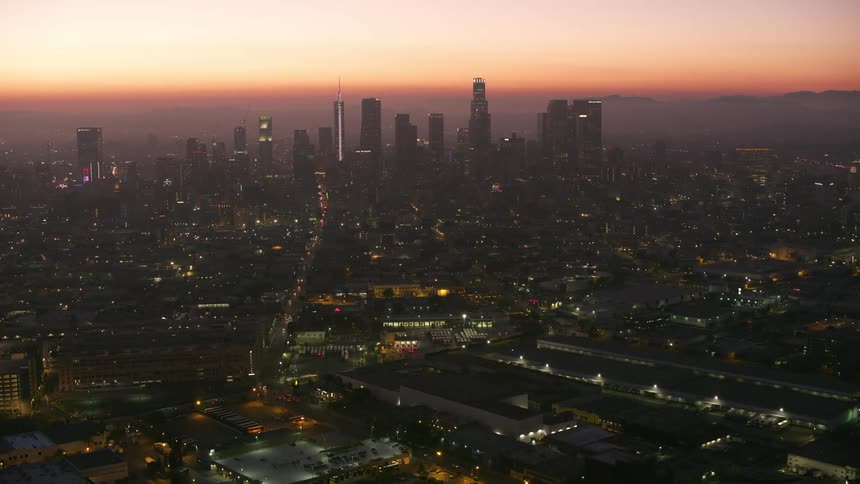 A cityscape dominated by a tower block at dusk