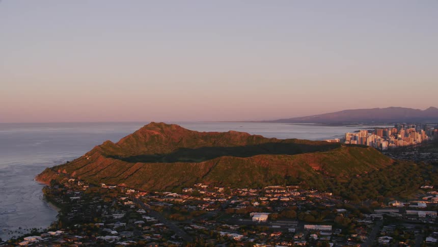 Forested crater on coast separates residential neighborhood from city