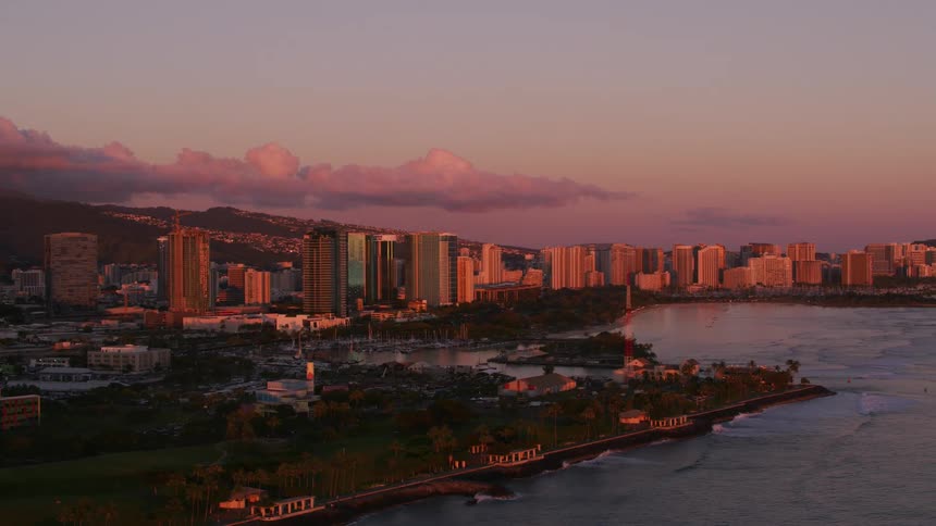 Aerial view of a downtown city during dusk is displayed