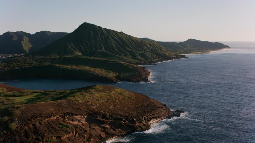 Drone view of the ocean meeting mountain ranges on the coast