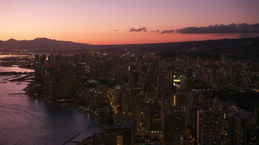 Aerial view of a downtown city while the sun is setting