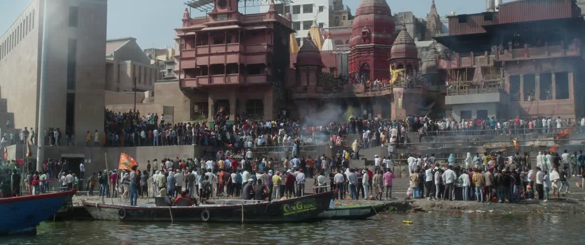 A crowd gathers on a pier