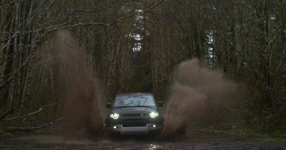 A suv driving off road through a large puddle