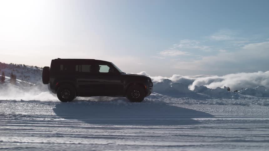 Black suv car drives on snowy water