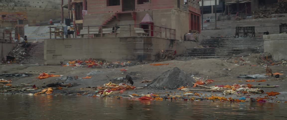 A dirty waterfront with garbage all over it
