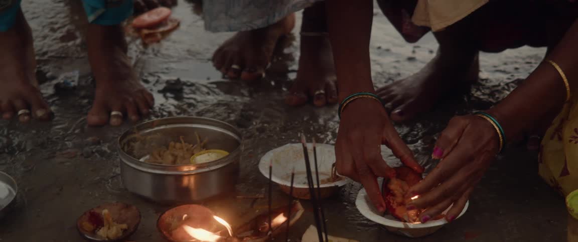 An indigenous group cooks outdoors