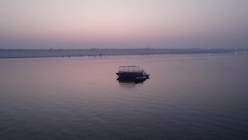 Aerial view of ferryboat floating on water at sunset