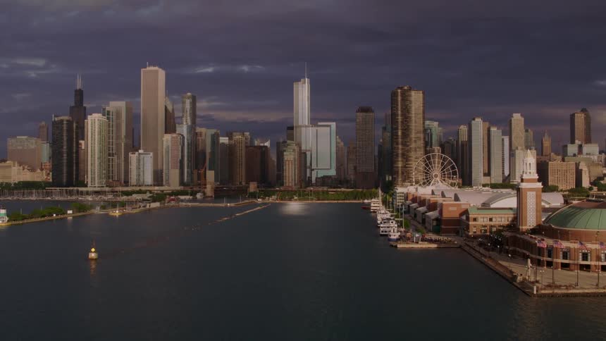 A ferris wheel sits along the coast near downtown