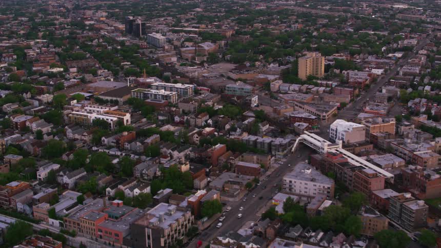An aerial view of a sprawling suburb with apartment buildings and houses