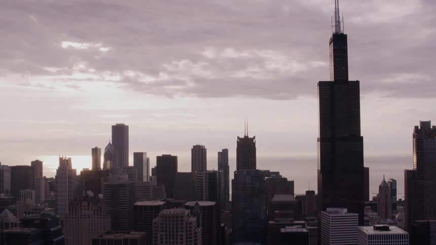 Aerial view of skyscrapers and high rise buildings in the city at dusk