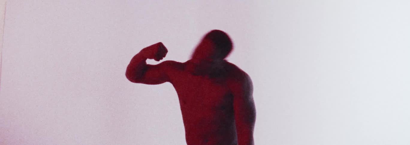 Topless man with earrings dances in the studio