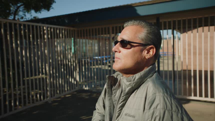 Portrait of disabled man with sunglasses earrings and gray jacket
