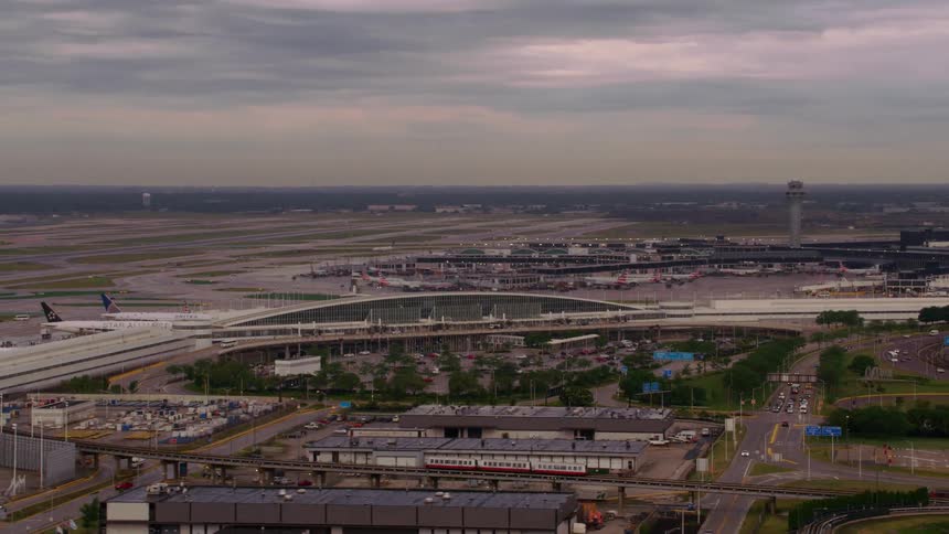 Aerial view of city near coast with airport and commercial airlines daytime and overcast