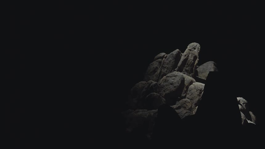 Light shines on a pile of rocks in the darkness search light helicopter drone light