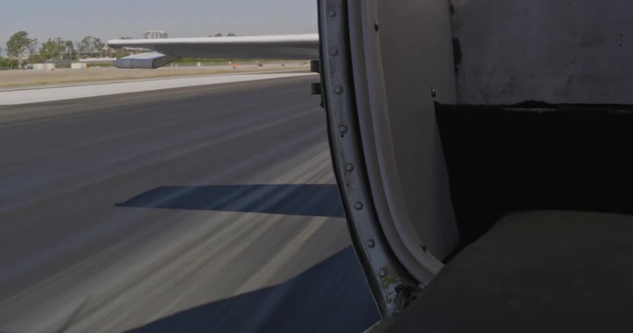 The tail wing of an airplane bounces as it moves down the runway