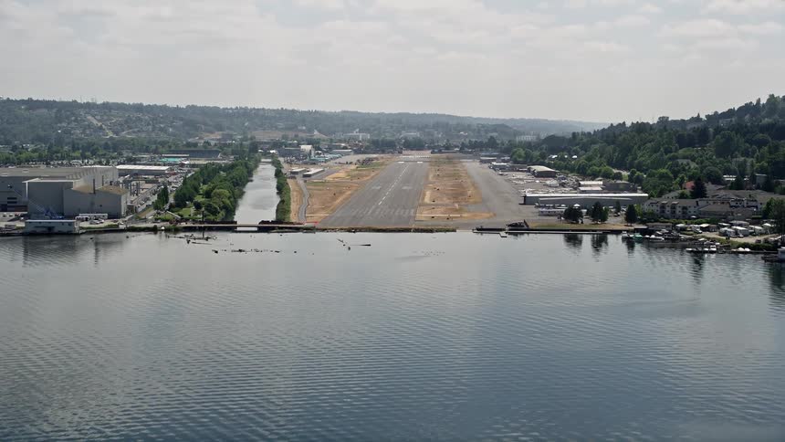Aerial view of approaching Renton Municipal Airport runway from Lake Washington on a cloudy day in Washington State
