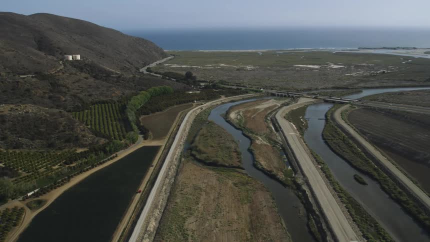 Streams run through a field below rolling hills