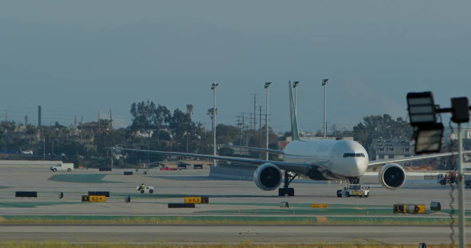 Airplane slowly moving on the runway at the airport