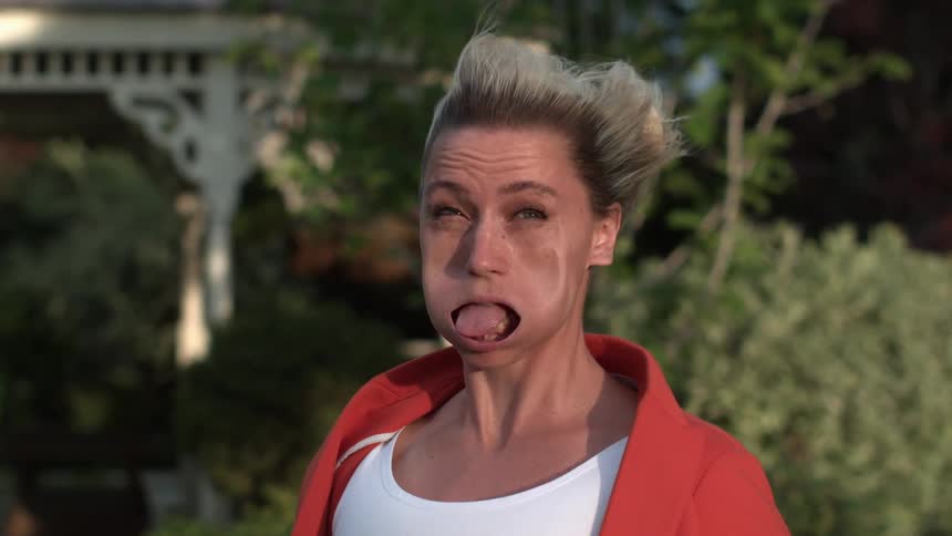 A woman's face is warped by strong wind in extreme slow motion