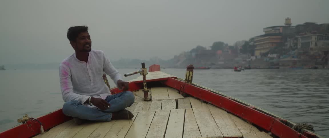 A man adjusts the sail on his boat