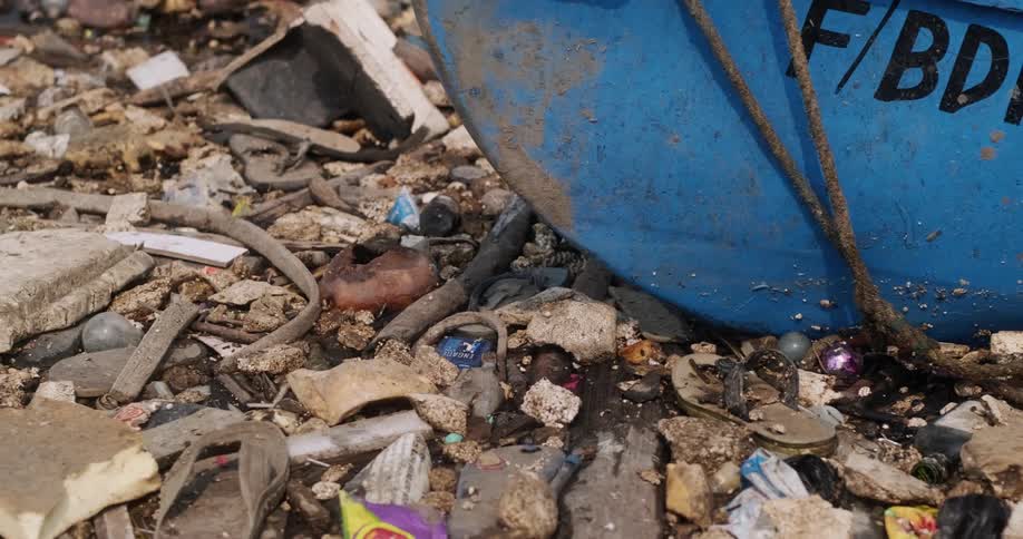 A boat is stopped by trash filling the water